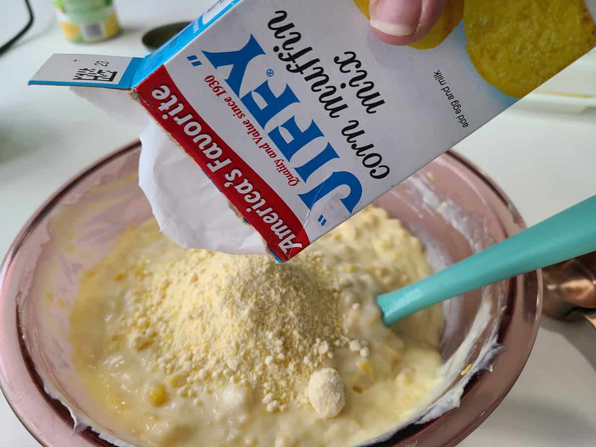 emptying a Jiffy box into a bowl of batter