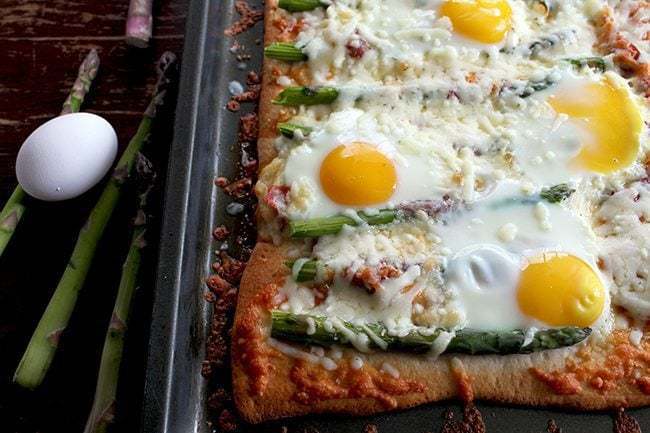 Breakfast Pizza with Asparagus, Capicollo and Eggs sprinkled with Cheese