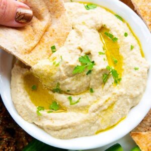 dipping an oven baked pita chip into Baba Ganoush