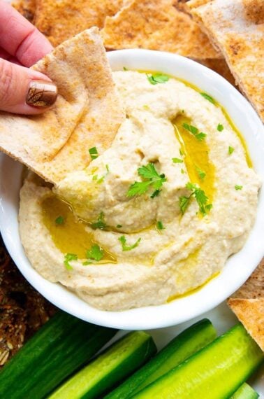 dipping an oven baked pita chip into Baba Ganoush