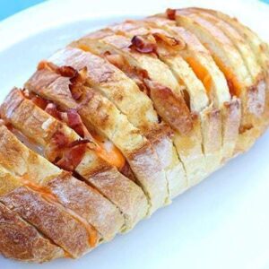 close up of Bacon & Cheese Pull Apart Loaf in a white plate