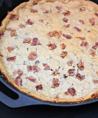 close up giant Chocolate Chip Cookie with bacon in a large Skillet