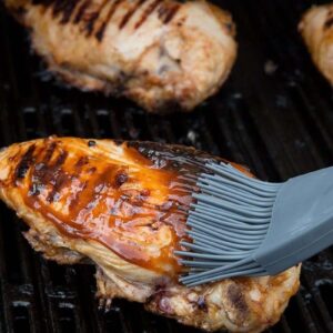 Brushing Barbecue Grilled Chicken with Marinade