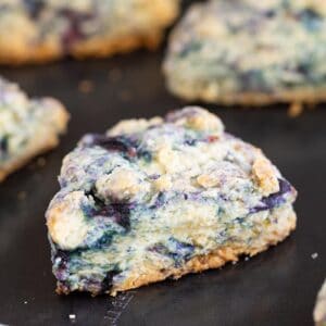 close up buttery blueberry scone on a baking sheet