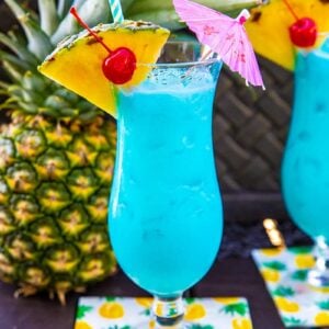 Blue Hawaiian Cocktail in a Hurricane Glass with a slice of pineapple