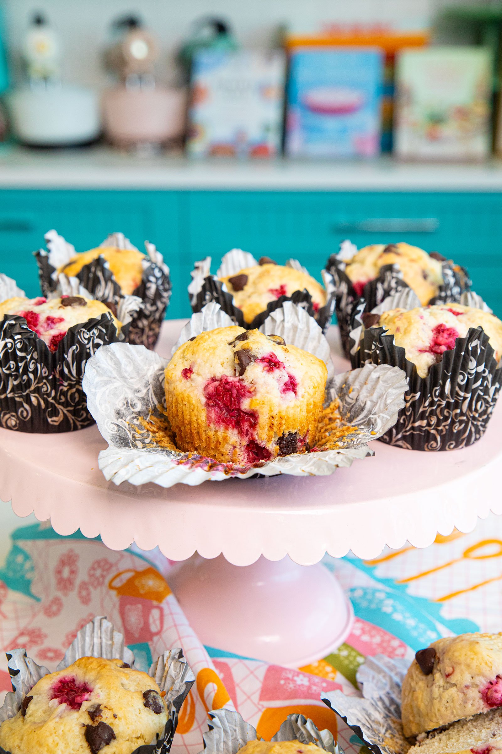 chocolate raspberry muffins on a pink cake stand