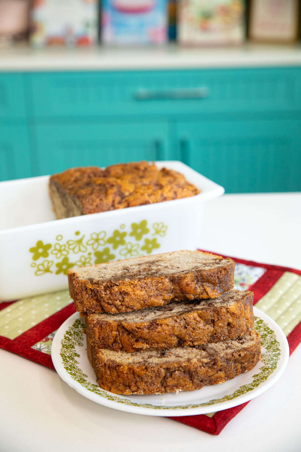 cinnamon swirl bread in a loaf pan in a kitchen