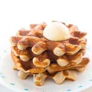 Close up of Keto waffles on a white Corelle plate and butter on top