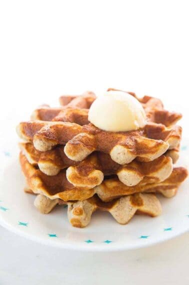 Close up of Keto waffles on a white Corelle plate and butter on top