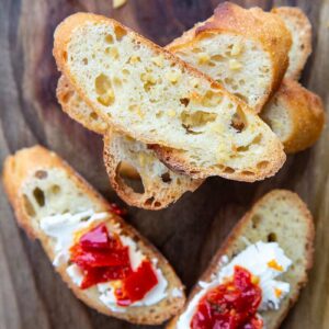 Crostini with some toppings on a wood background