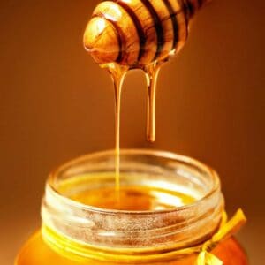 Honey in jar with honey dipper