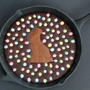 top down shot of Skillet Brownie with a chocolate bunny smack dab in the middle, surrounded by colored M&M's