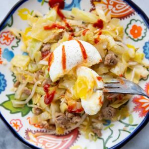 close up Egg Roll in a Bowl with poached egg on top