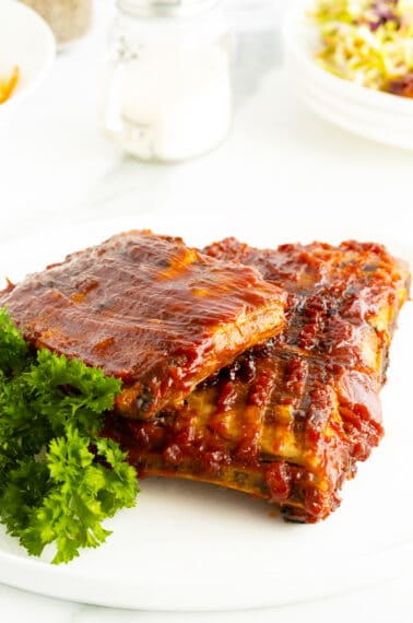 glazed spareribs unsliced on a plate with parsley