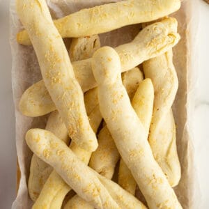 home made breadsticks on a piece of parchment