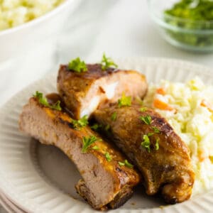 honey mustard glazed ribs sliced and stacked on a white plate