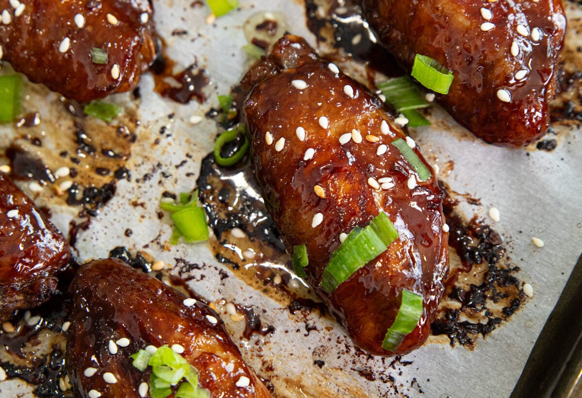 stick honey sesame chicken wings on a baking sheet