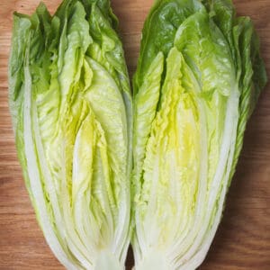 romaine lettuce sliced lengthwise on a cuttingboard