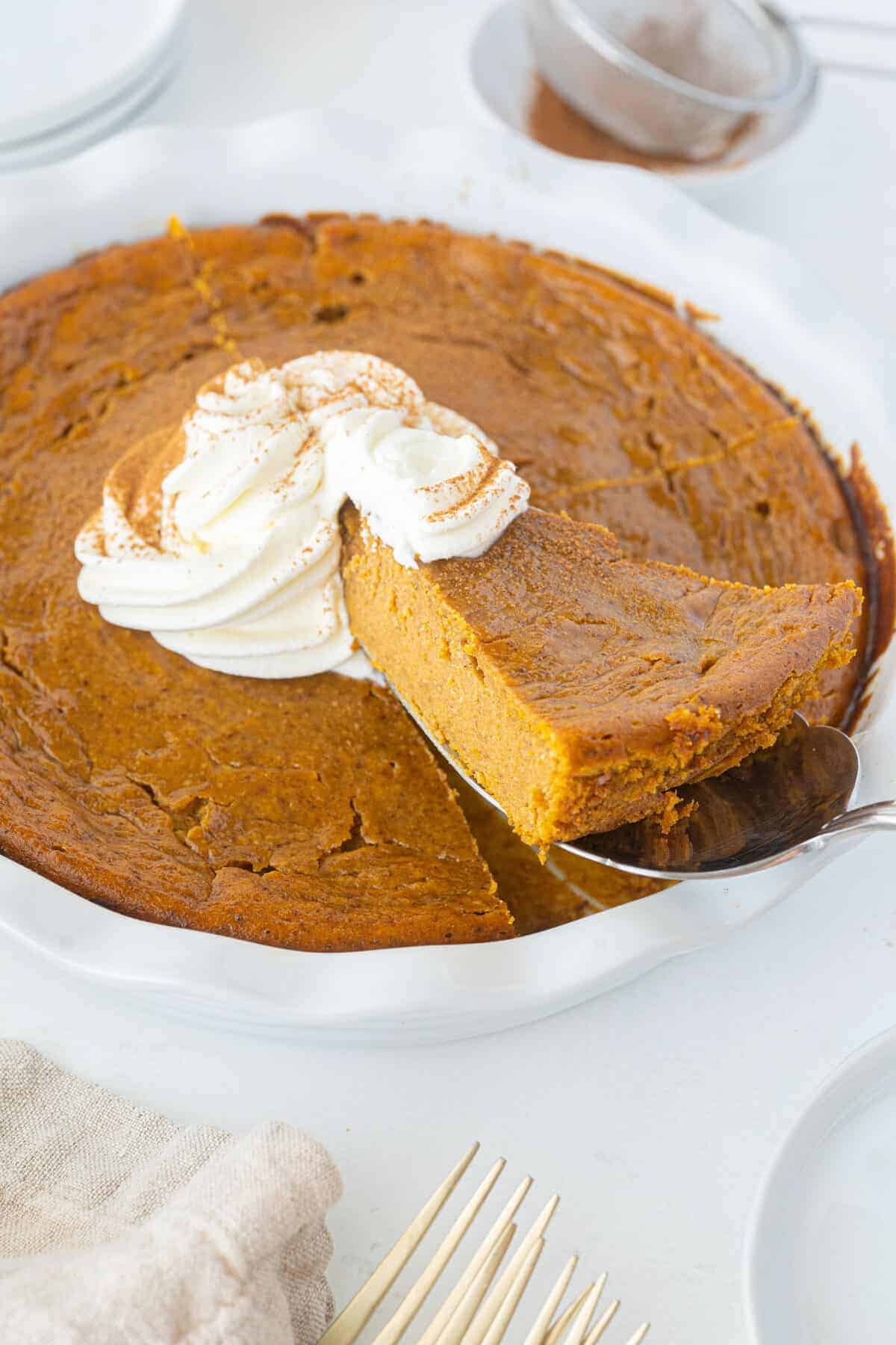 impossible pumpkin pie slice in a white pie plate