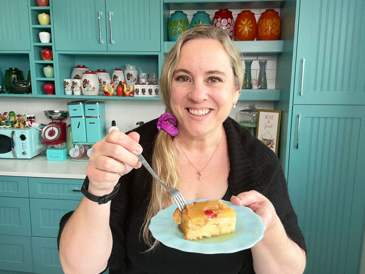 Karlynn holding a plate of pineapple upside down bread pudding