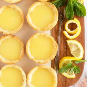 Lemon Tarts on a brown cutting board