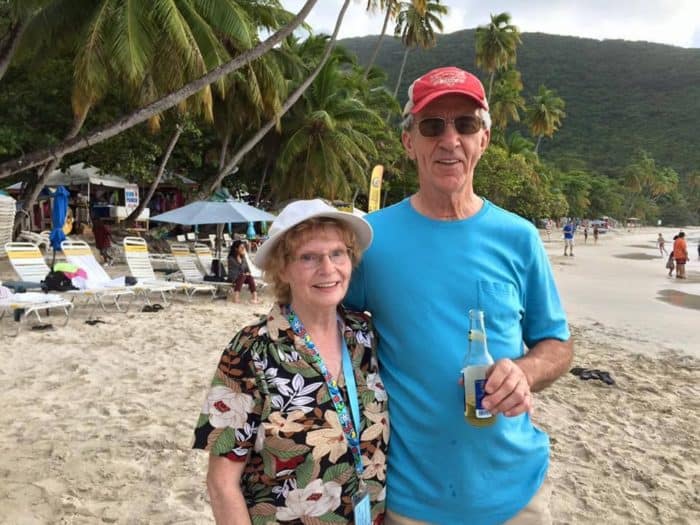 Mom and Dad holding a bottle of drink at the beach