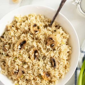 mushroom rice in a large bowl with a spoon