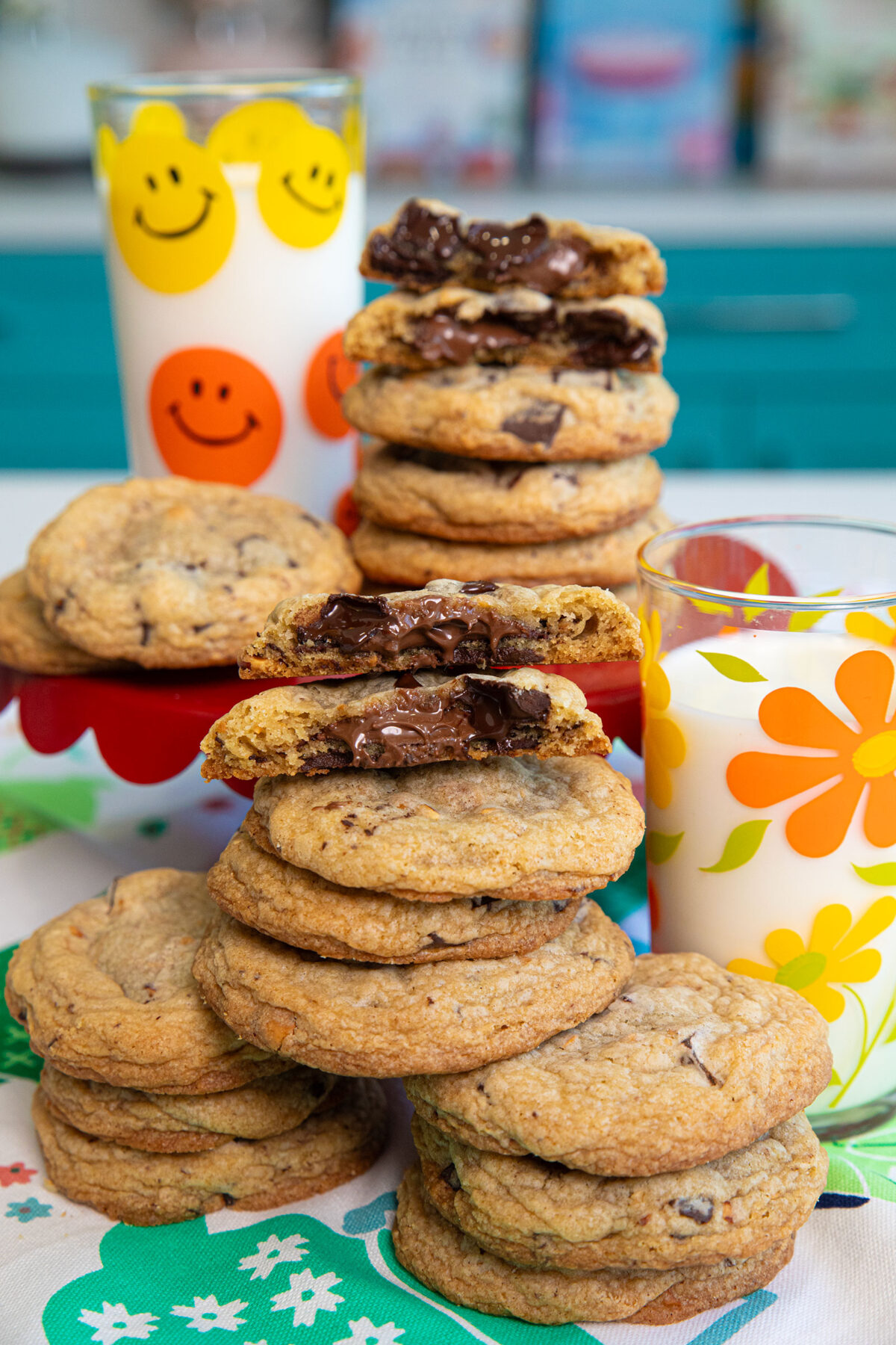 A stack of Nutella Stuffed Hazelnut  Chocolate Chip Cookies with a glass of milk