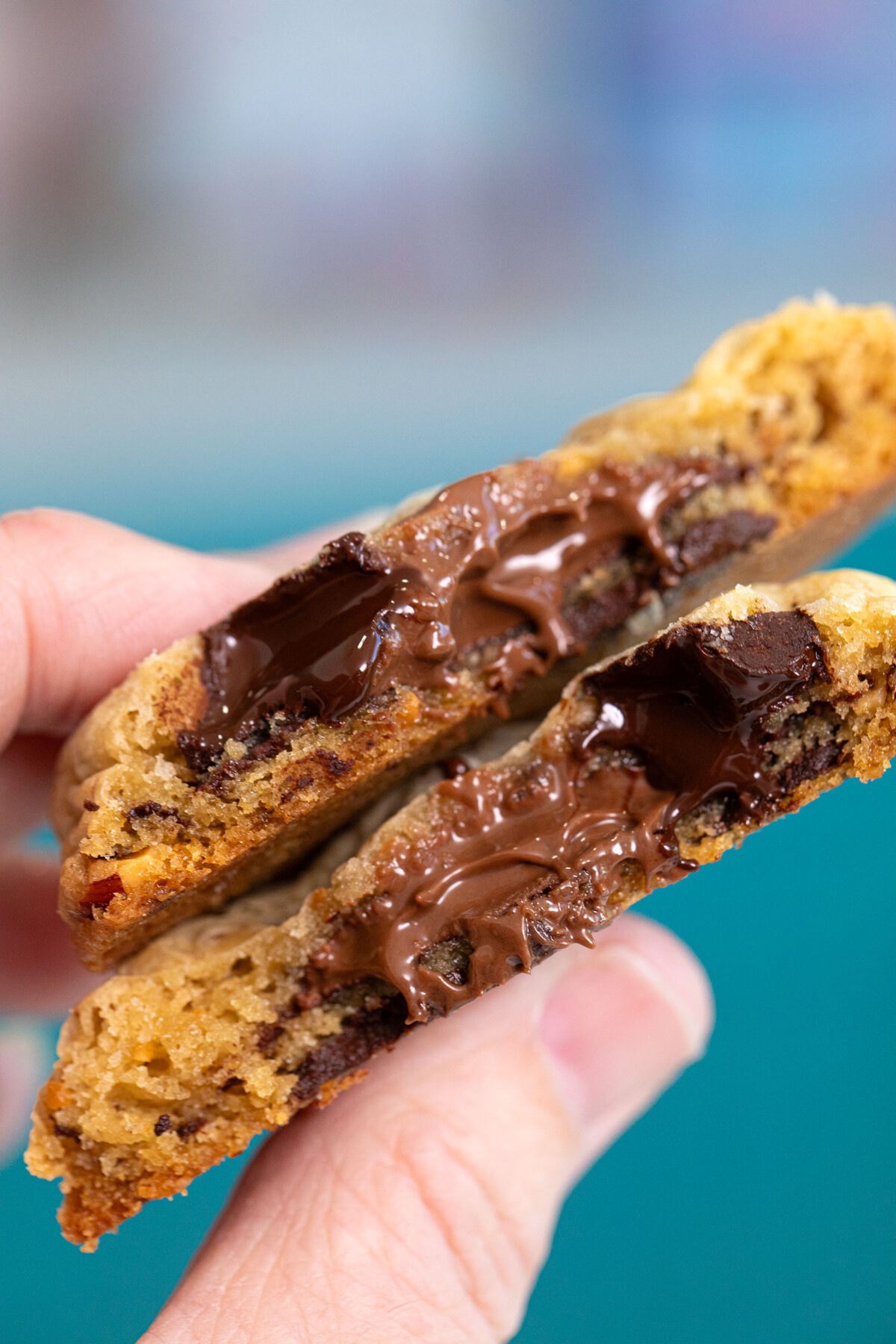 Nutella stuffed cookies cut in half close up of melted chocolate and Nutella in the cookie.