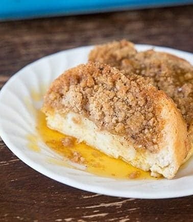 Slices of overnight french toast in white plate with cinnamon crunch toppings