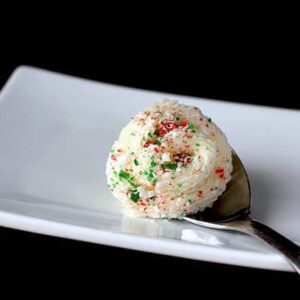 a spoon of Peppermint Buttercream Frosting in a white plate