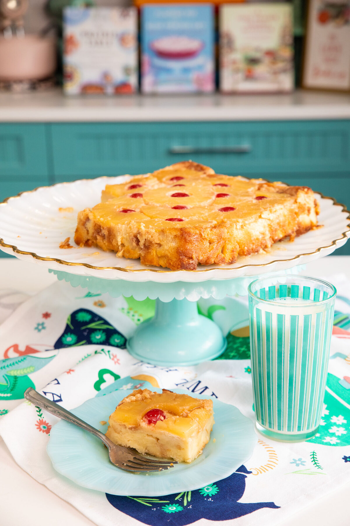 pineapple upside down bread pudding on a white cake stand 