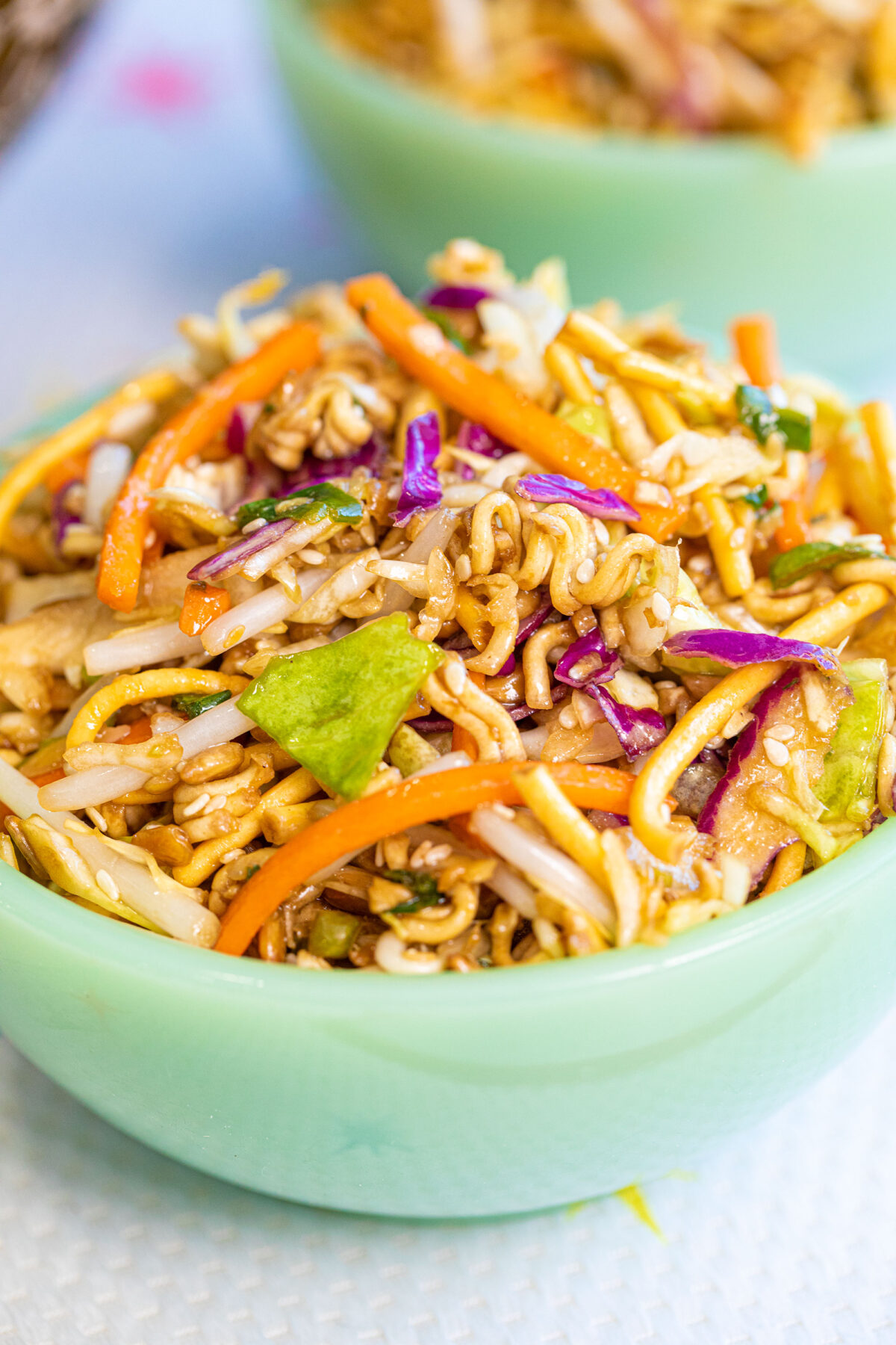 a close photo of ramen noodle salad in a green Jadeite bowl