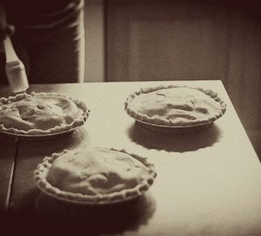 3 pieces of saskatoon pie in pie dish ready for baking