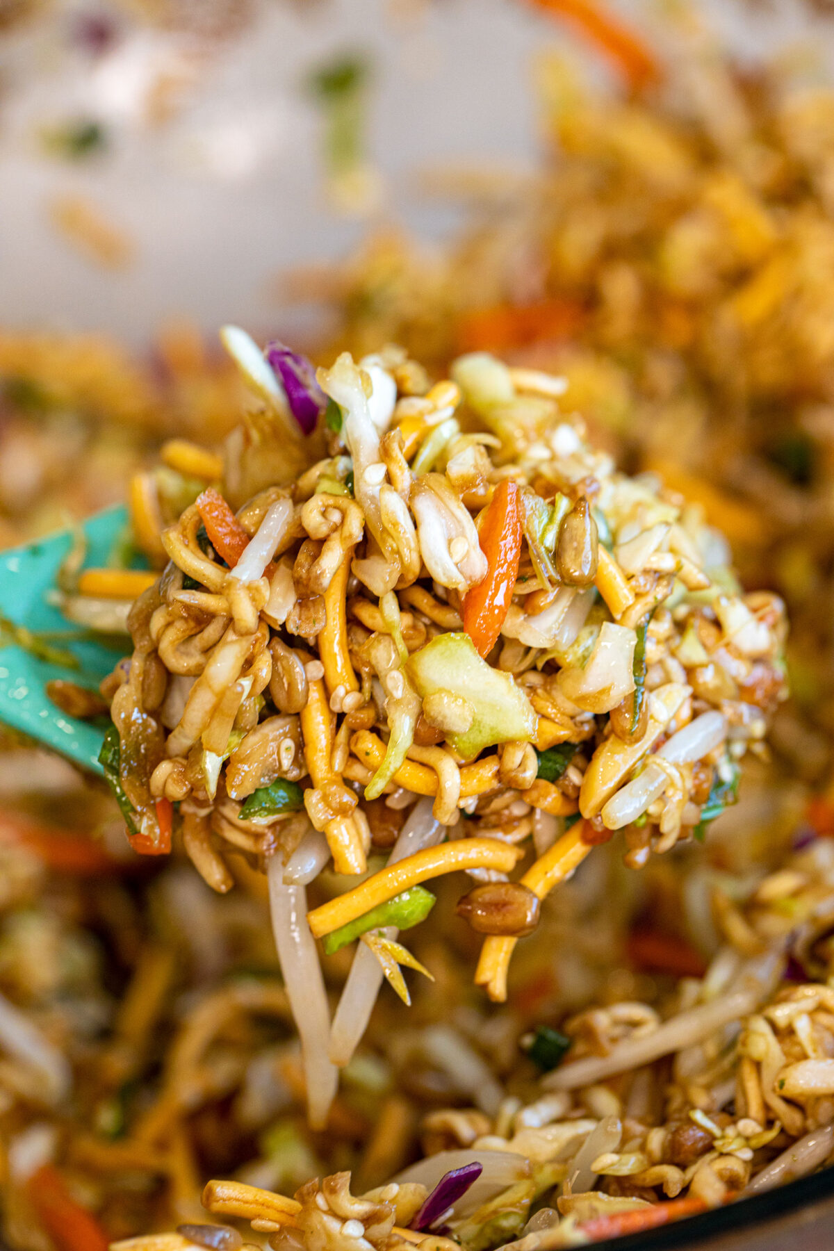 a scoop of ramen noodle salad on a spoon