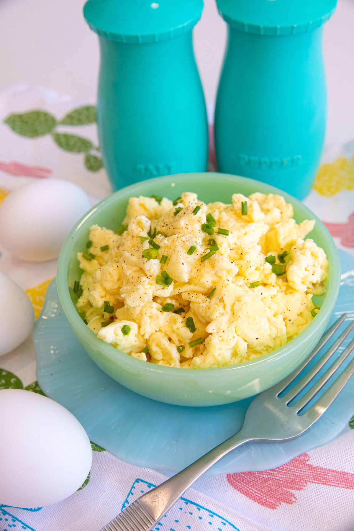 a bowl full of sour cream scrambled eggs and a fork