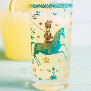 close up of Sparkling Honey Bourbon Lemonade in a glass with Arabian design garnish with a slice of Lemon