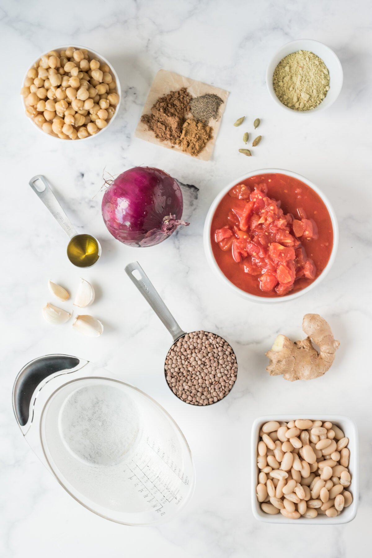 ingredients in small bowls to make spicy bean and lentil soup 