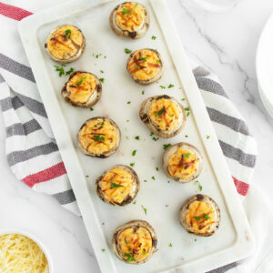 Stuffed Mushrooms lined up on a cutting board