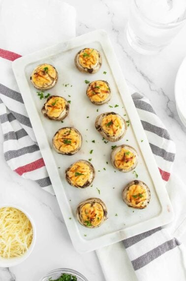 Stuffed Mushrooms lined up on a cutting board