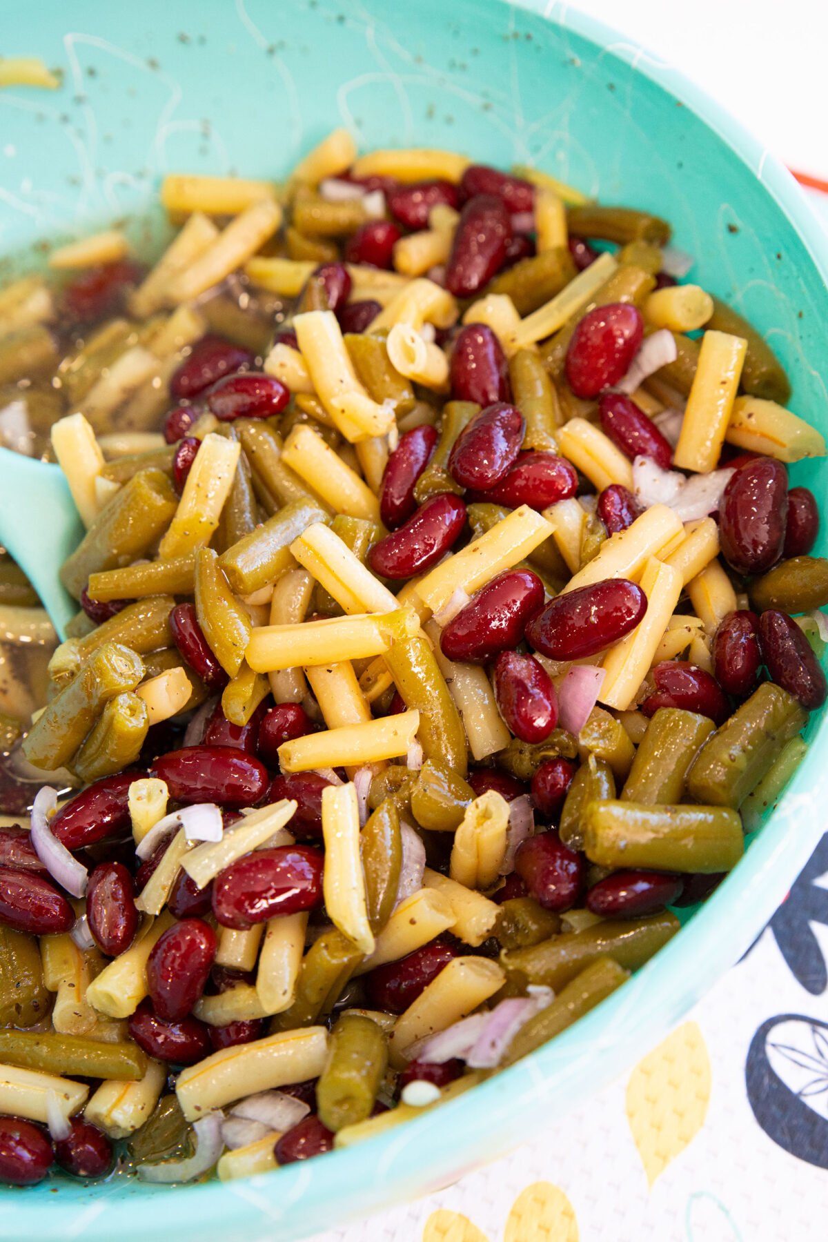 three bean salad in a large blue bowl