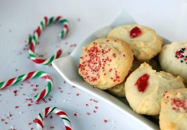 close up Old Fashioned Whipped Shortbread in a white plate, some candy cane on table